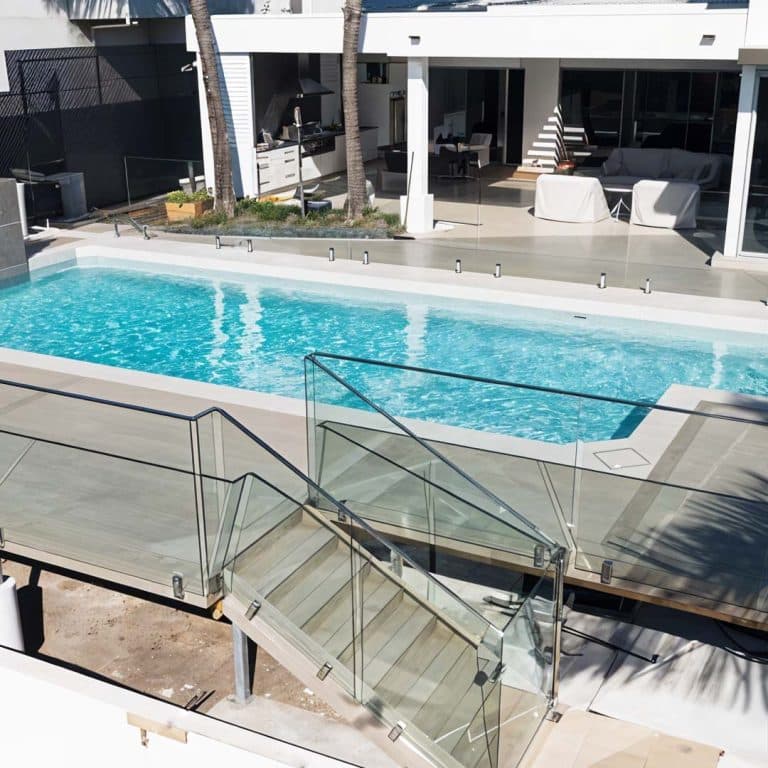 Elegant glass pool fence installation providing safety and unobstructed views