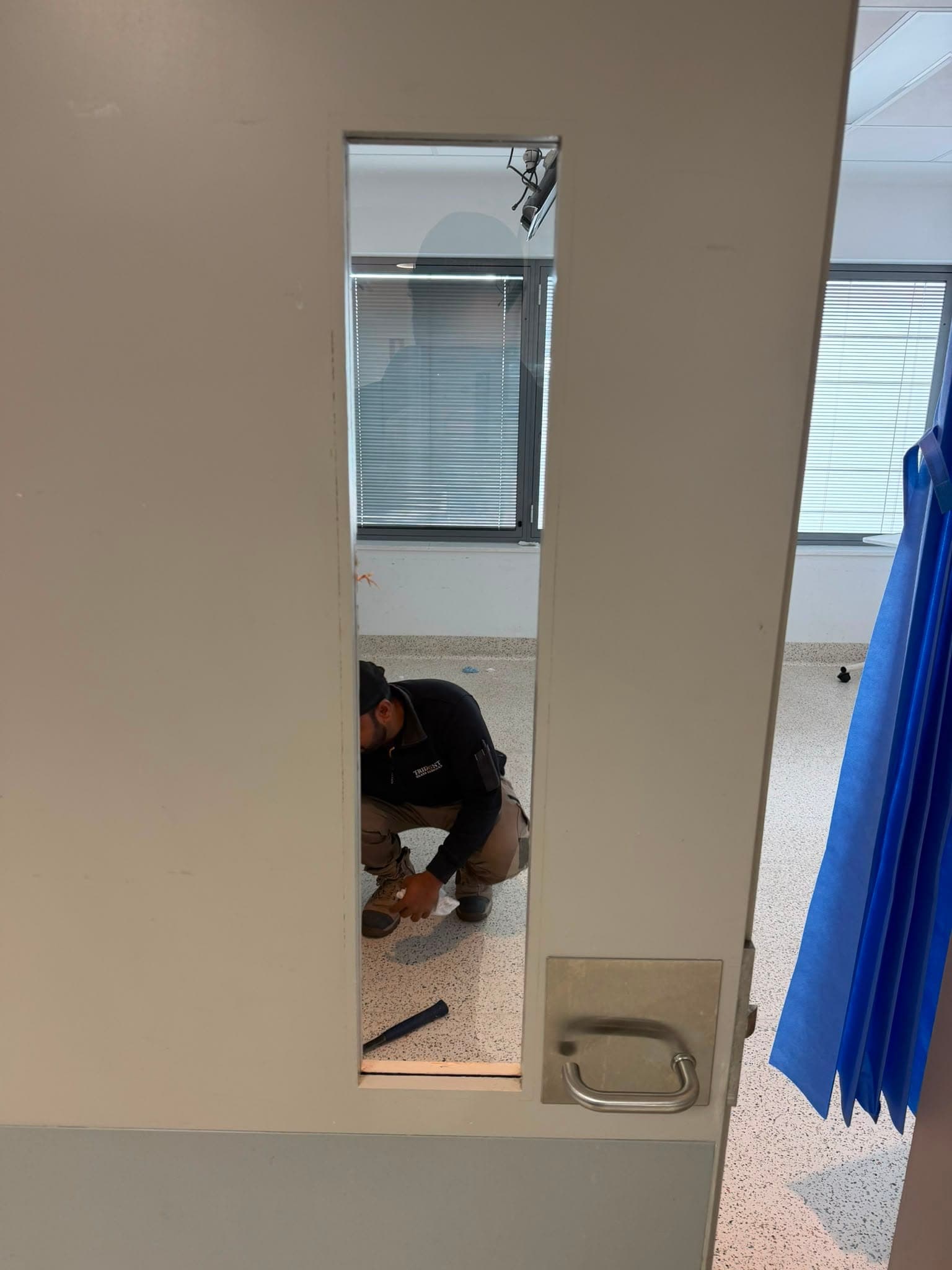 Custom cut vision panel glass fitted to a commercial door
