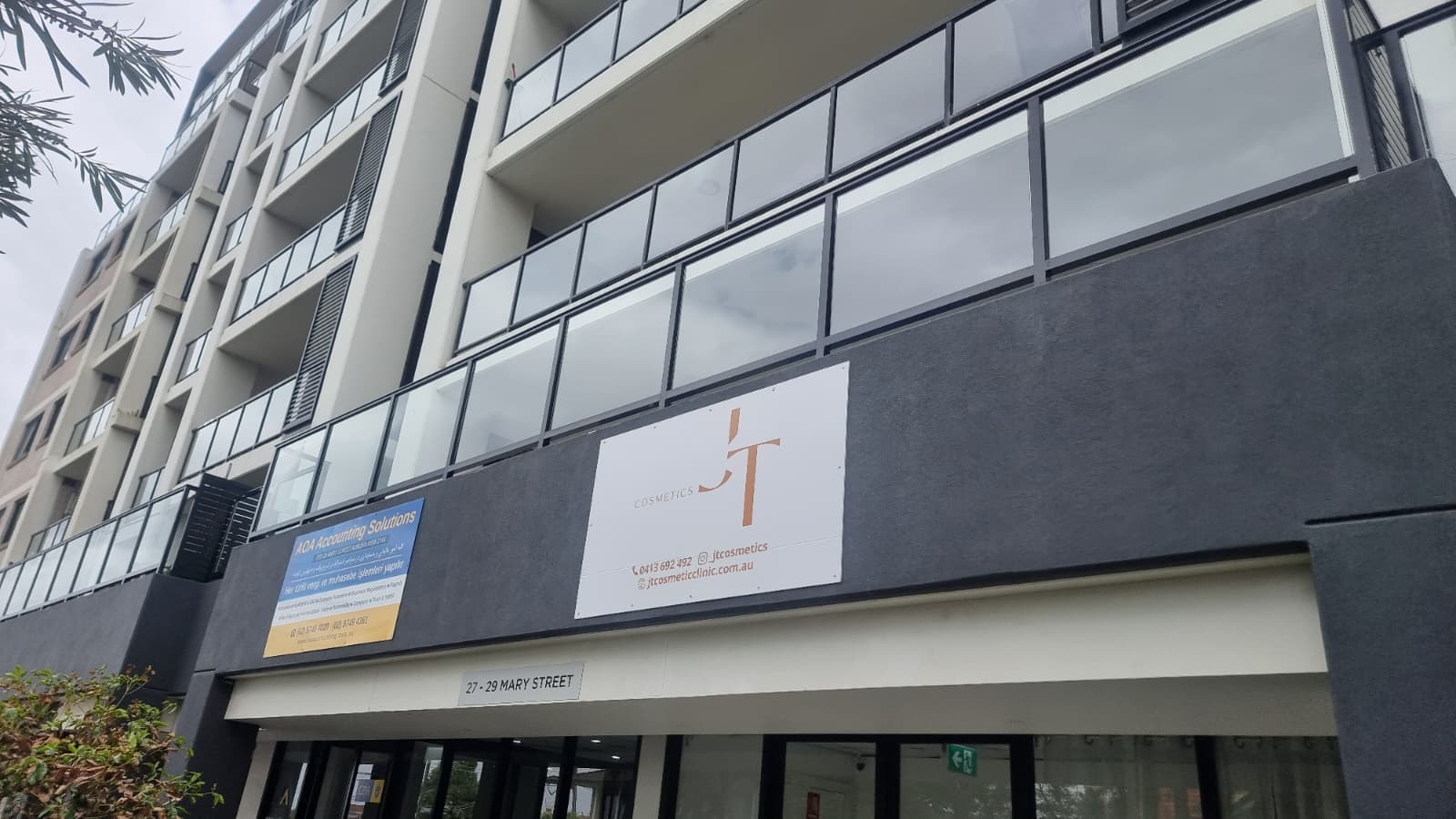 Front elevation of residential apartment featuring installed glass balustrade balcony panels
