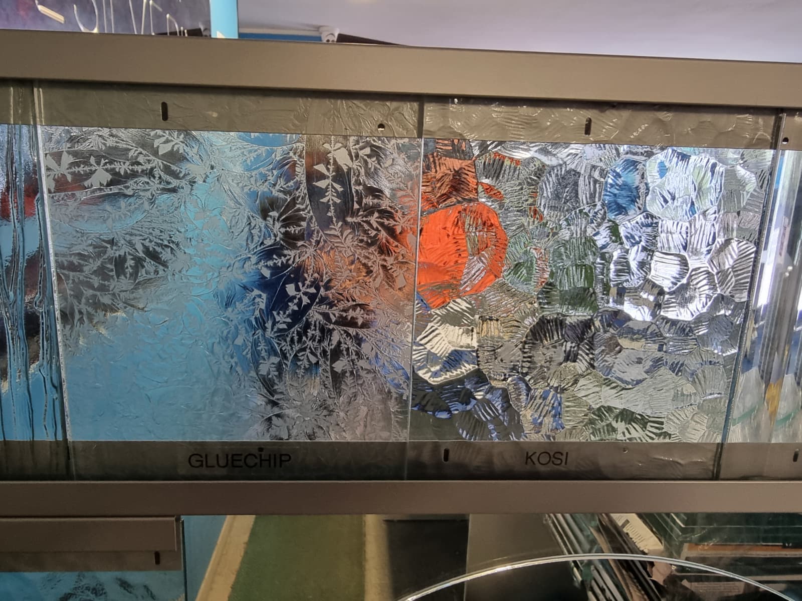Decorative patterned glass samples showcasing textured privacy glass designs
