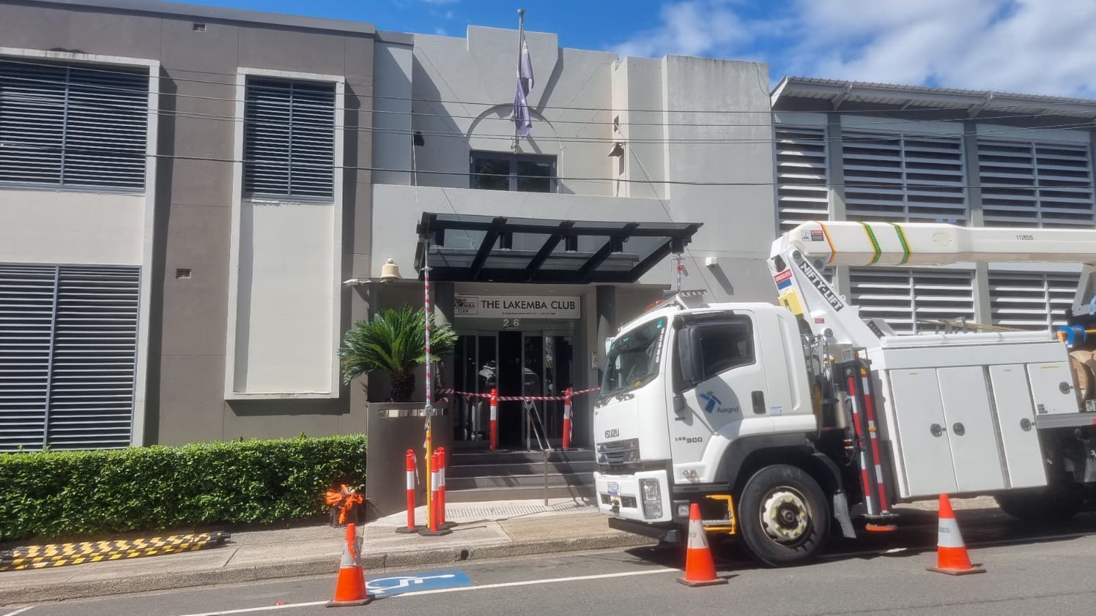 Commercial glass awning installed above building entrance for weather protection
